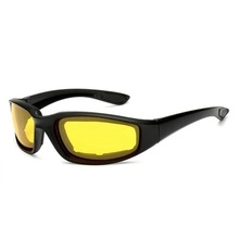 Macro detail of streamlined black frame sports sunglasses with yellow night vision lenses