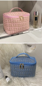 Close-up of pink and blue tweed cosmetic bags with gold zippers and top handles
