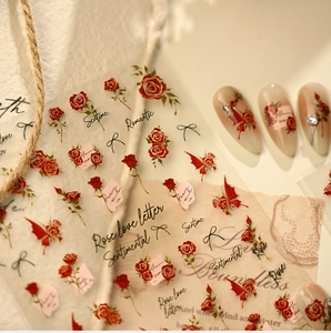 Macro detail of French chic red rose nail stickers with script and bow designs