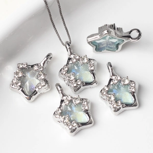 Detailed view of silver star charms with cubic zirconia and iridescent resin inlays