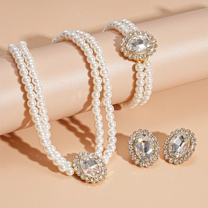 Detailed view of luxury pearl jewelry set with oval crystal necklace and bracelet