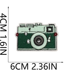Detailed view of green camera embroidery patch measuring 6cm x 4cm with dimensions