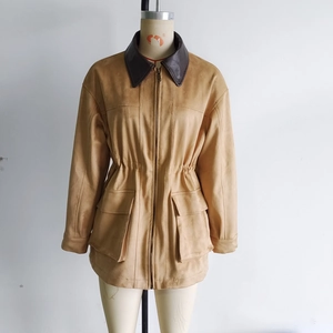 Detail of camel suede jacket showing contrast collar, large pockets and waist drawstring