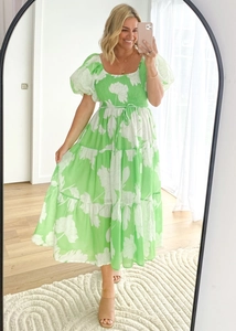 Detail of green floral print dress with puff sleeves and tiered skirt on mirror selfie