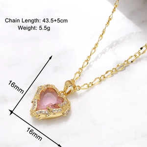 Detail of pink heart pendant necklace with gold frame and sparkling zircon stones