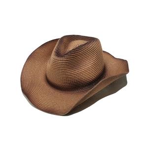 Detail view of woven gradient brown western cowboy straw hat with vintage burnt edge texture