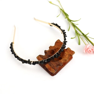 Detail view of handmade gold wire hairband featuring black natural crystal stone chips