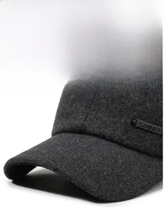 Close-up of dark grey wool winter cap featuring a side label and reinforced brim