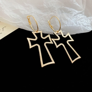 Detail view of gothic cross hoop earrings in gold alloy with black enamel finish