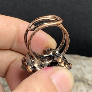 Close-up of vintage copper adjustable ring with irregular raw amethyst stone texture
