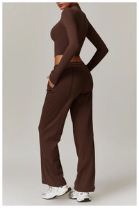 Detail view of deep brown high-neck fitness top and matching wide-leg yoga trousers
