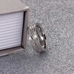 Macro detail of silver titanium steel ring with geometric diamond carving and gear texture