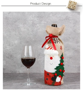 Close-up of burlap Christmas wine bottle cover with embroidery and red ribbon