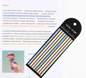 Detail of colorful transparent PET sticky strips placed on a book page for indexing