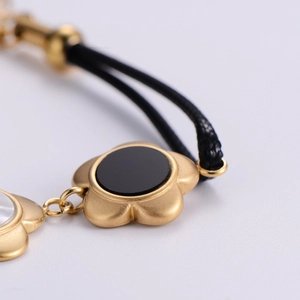 Double-layered 18k gold plated plum blossom bracelet with black enamel insets