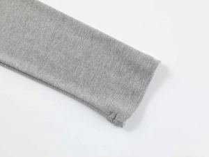 Macro detail of the fine stitching and stretchy gray modal fabric on the sleeve cuff