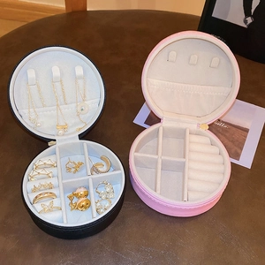 Detail of round PU leather jewelry box with compartments for rings and necklaces