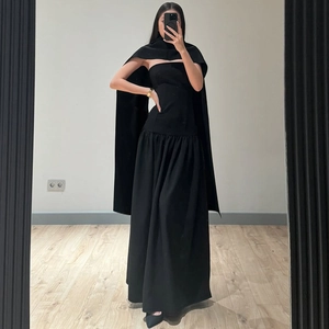 Detail of minimalist black three-piece set featuring tube top, long skirt, and matching shawl