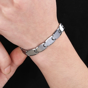 Close-up of polished silver magnetic tungsten steel link bracelet for men on wrist