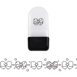 Detail view of cartoon animal roller stamp and decorative lace tape with bowknot patterns