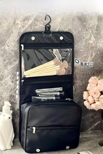 Hanging black toiletry bag with PVC compartments and storage hooks for travel