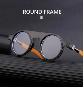 Detail of round frame sunglasses with orange temples on a minimalist textured pedestal