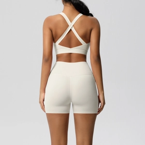 Rear view of cream yoga set showing cross-back sports bra and high-waist shorts
