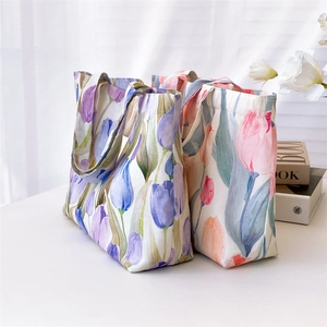Chic tulip floral canvas tote bags in purple and pinkish orange colors on white background