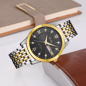Detail view of men's watch with gold-silver steel band and black dial with day-date display