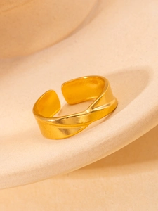 Detailed macro view of an adjustable 18K gold-plated twisted ring with brushed texture