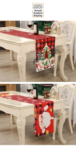 Close-up of red buffalo plaid Christmas runner with Santa Claus and gnome patterns
