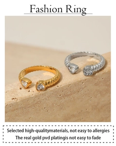 Macro detail of gold and silver twisted rope rings with heart-shaped zircon stones