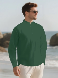 Detailed texture of dark green cotton linen shirt with mandarin collar on beach rocks