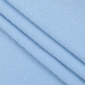 Detailed macro view of light blue lace fabric texture with elegant fine knitting patterns