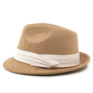 Detailed view of camel suede fedora hat with white pleated ribbon and short brim