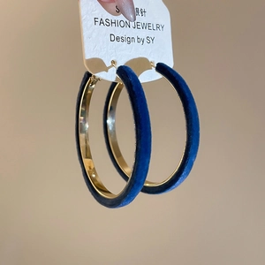 Detail view of large hoop earrings with deep blue velvet texture and S925 silver needles