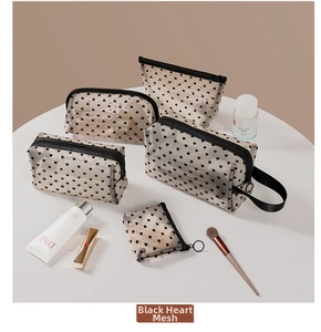 Close-up of five-piece beige mesh makeup bag set with black heart flocking patterns
