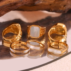 Set of six gold-plated stainless steel rings with white shell and small diamond accents