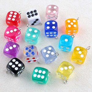 Detailed view of colorful acrylic dice pendants with metal rings for DIY jewelry making