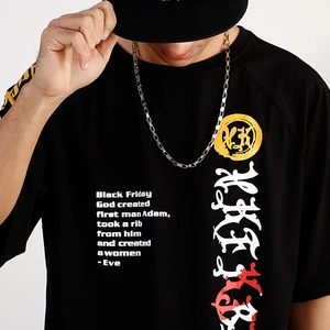 Detail shot of a silver box chain necklace on a black graphic tee with white gothic lettering