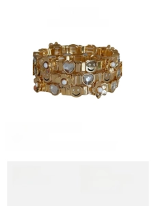 Detail showing gold plated elastic bracelet set with heart, smiley face, and flower charms