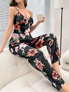 Detail of floral satin pajama set showing V-neck camisole and smooth printed texture