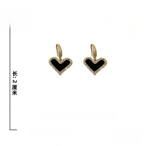 Detail view of heart drop earrings with dimensions 2x1.5cm and 6g weight specs