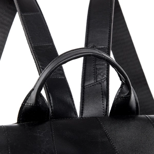 Close-up of top handle and reinforced stitching on this black leather commuter backpack