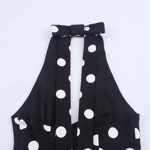 Detailed view of polka dot halter neck top with a stylish bow tie collar design