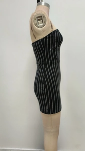 Detail of black bodycon mini dress featuring white vertical stripes and tube top design