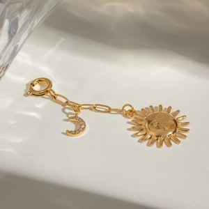 Elegant gold stainless steel sun and moon charm pendant with sparkling crystals and spring clasp