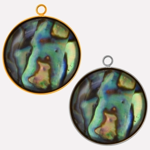 Macro view of gold and silver rimmed abalone shell pendants with natural iridescent texture
