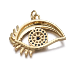 Detail of gold evil eye pendant with blue zircon stones and polished gold plating
