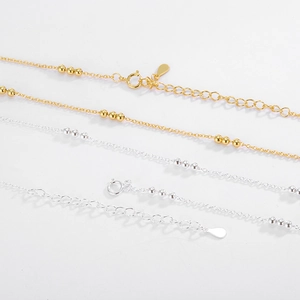 Detail of adjustable S925 sterling silver bead necklace with spring clasp and gold finish
